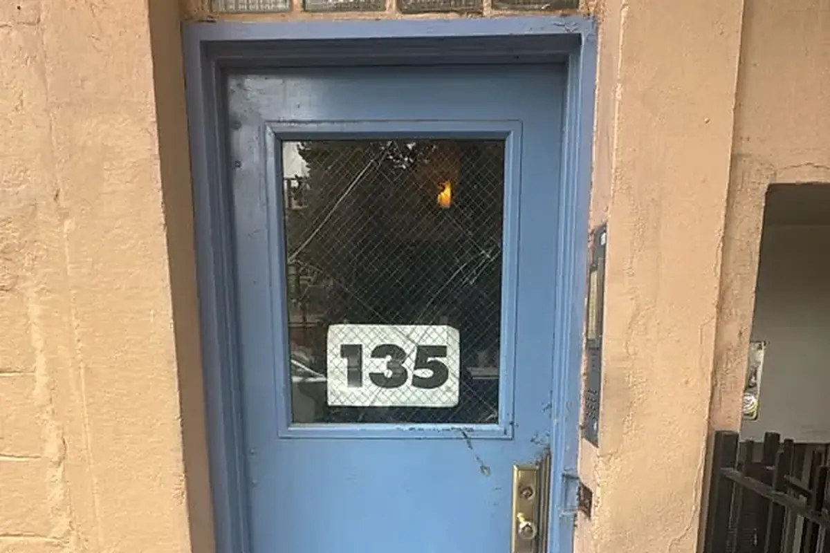 Actual blue commercial service door with cracked wired glass awaiting repair