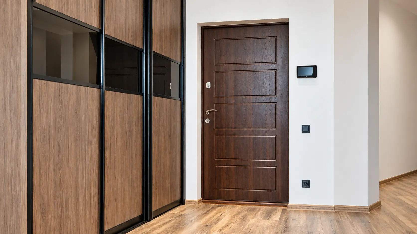 Refined wood entry door illustrating Manhattan door and hardware installations