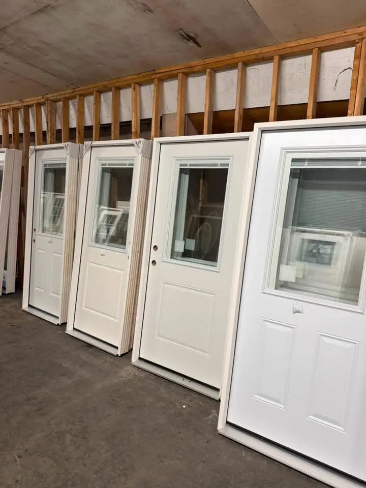 Rows of entry doors with windows in the Brenton Services warehouse