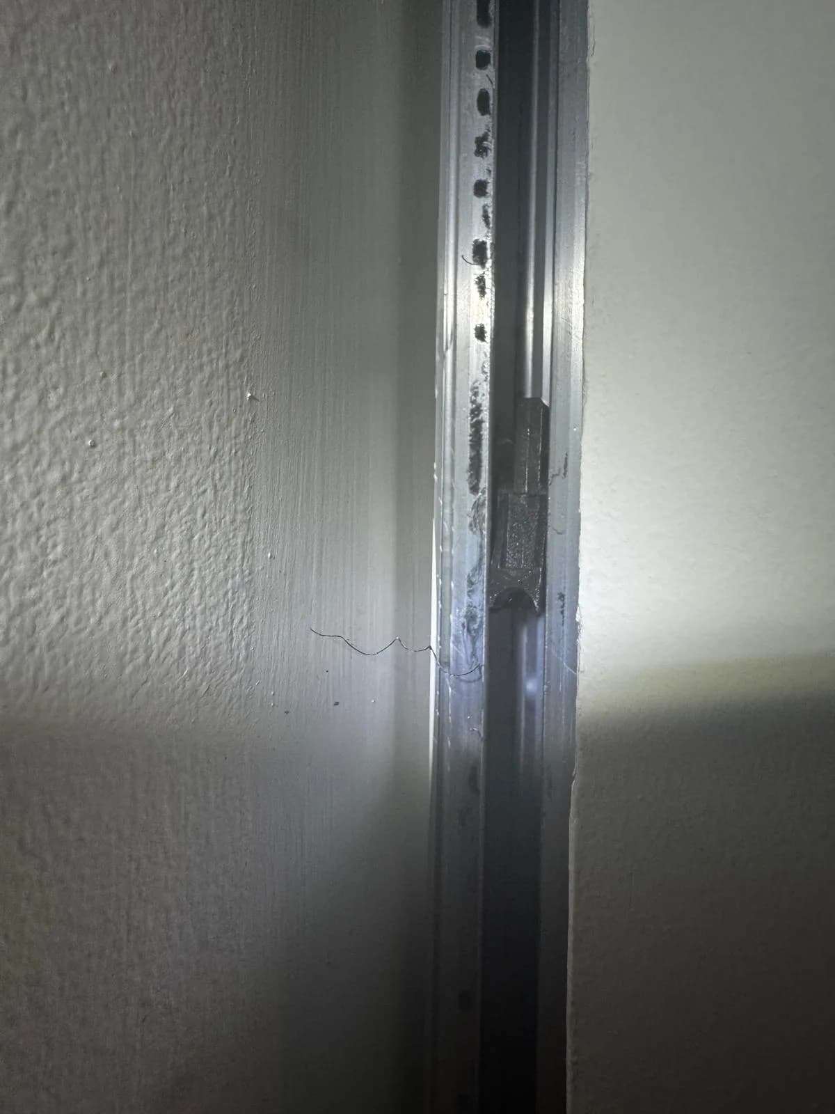 Close-up of a sliding door frame and track alignment