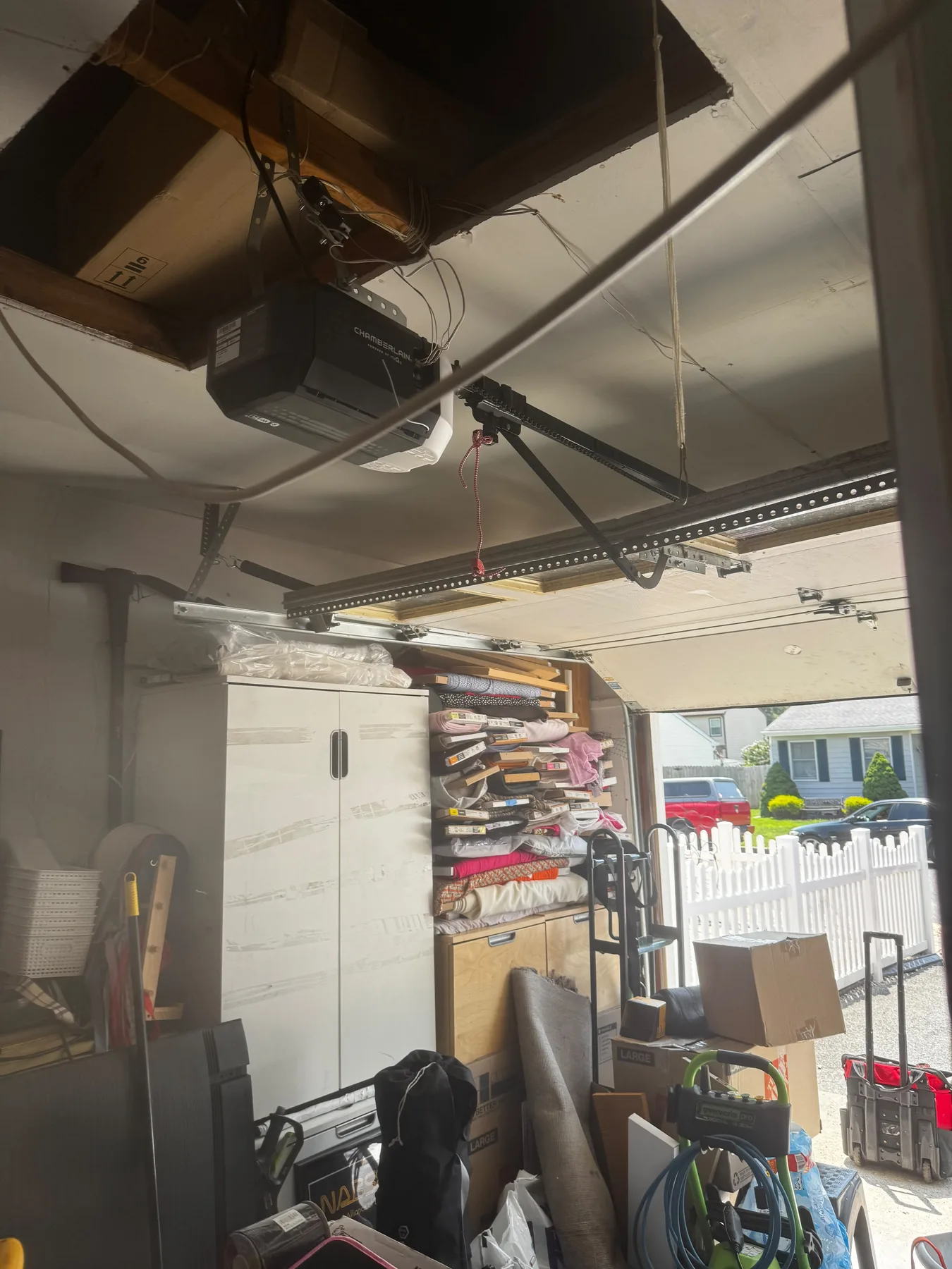 Ceiling-mounted garage door opener motor and rail