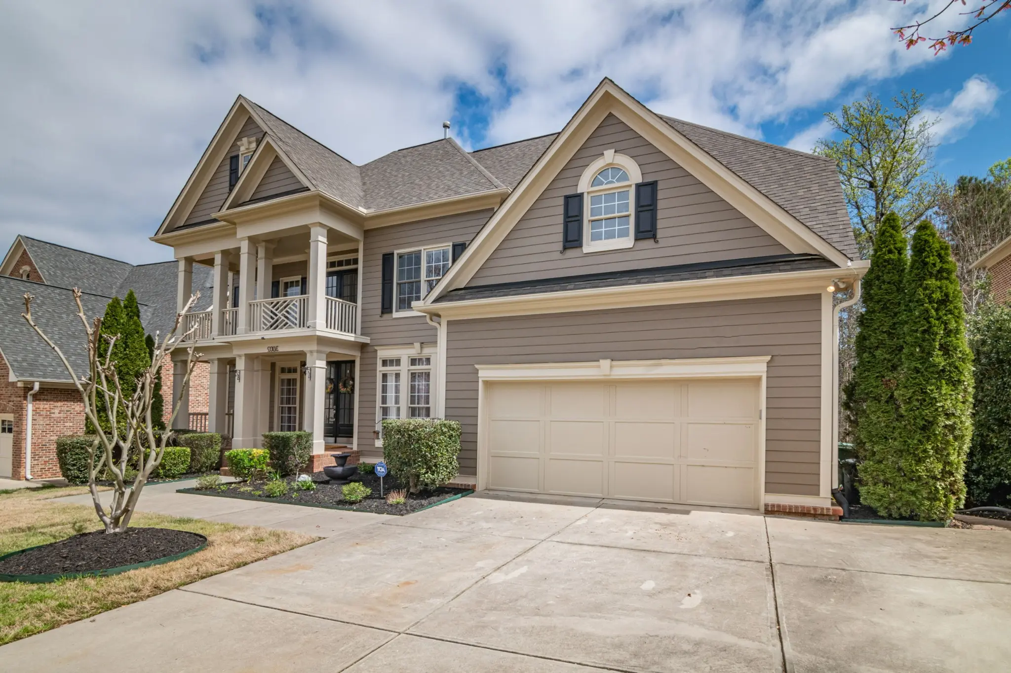 Residential home with a large garage door and front entry door