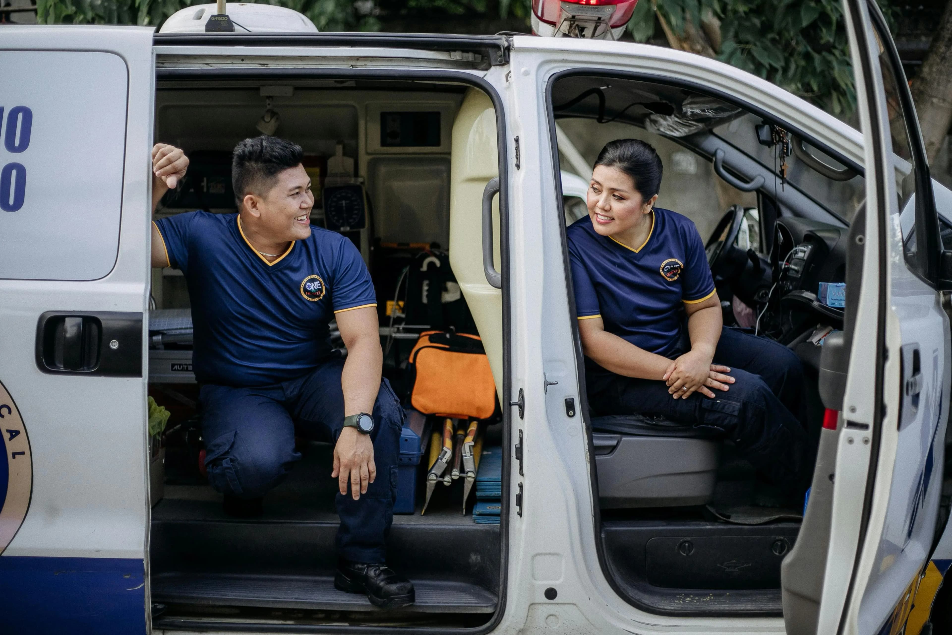Door service technicians standing beside their work vehicle
