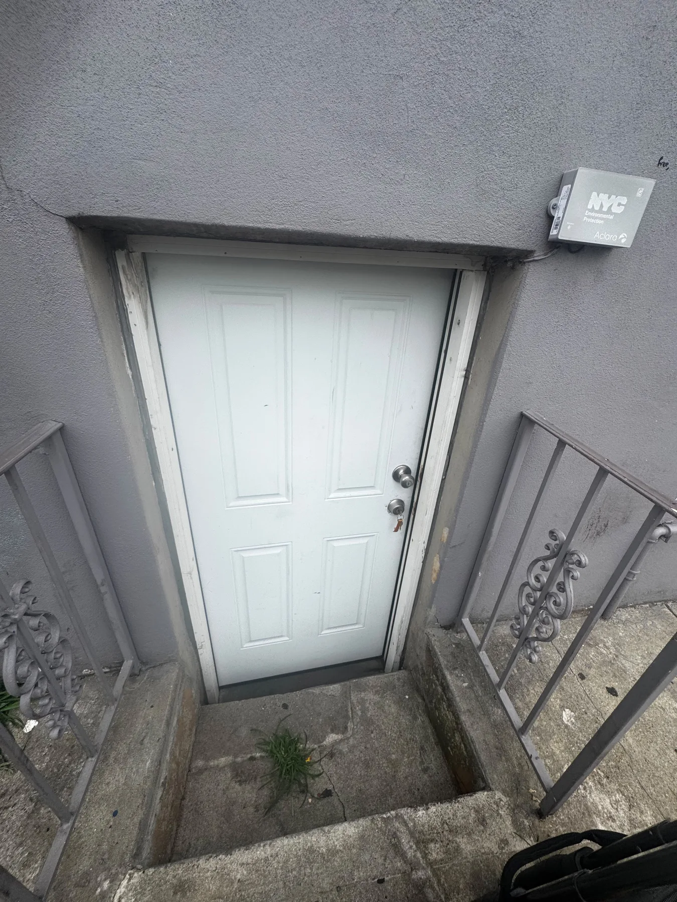 White exterior basement entry door before