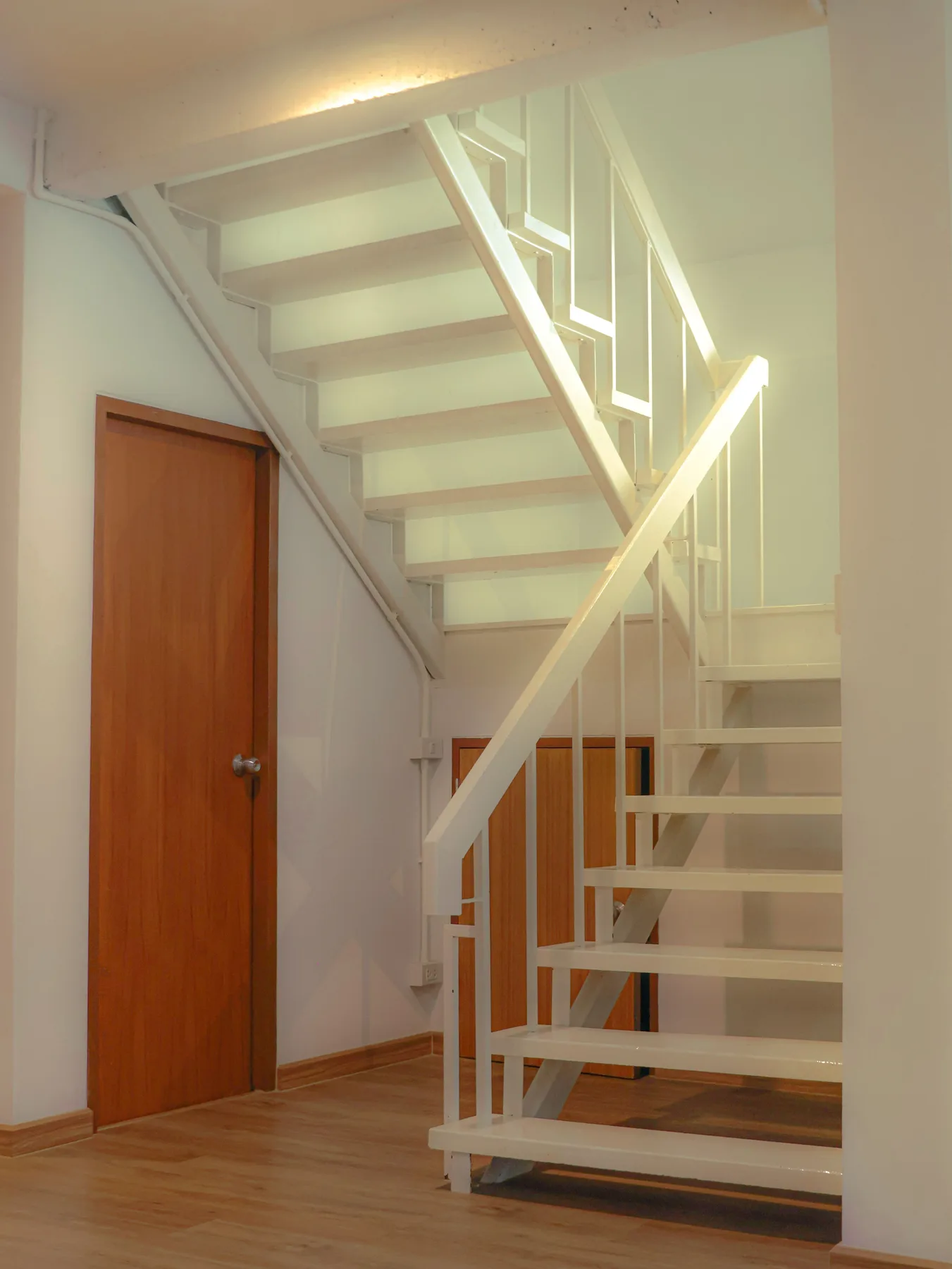 Wood staircase next to door