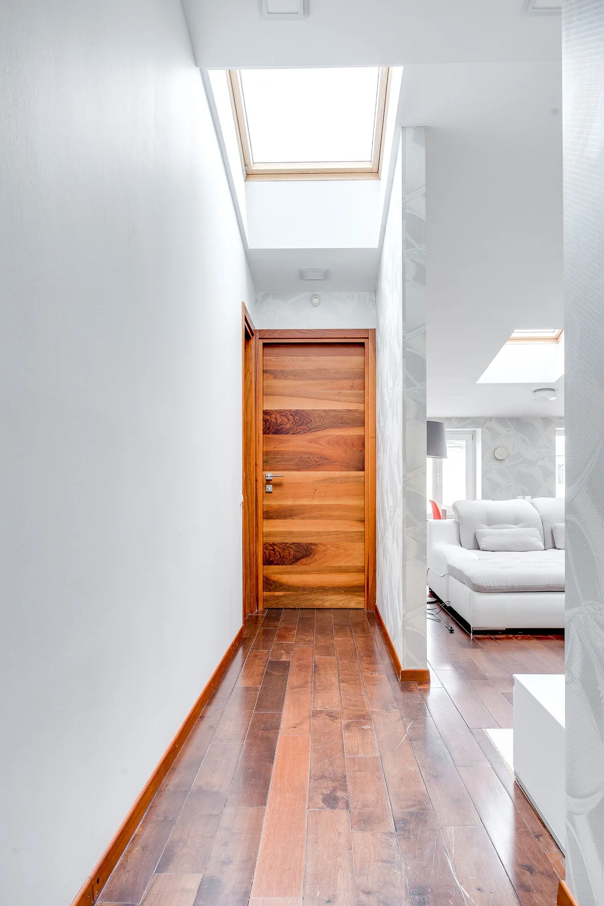 Wooden entry door white hallway