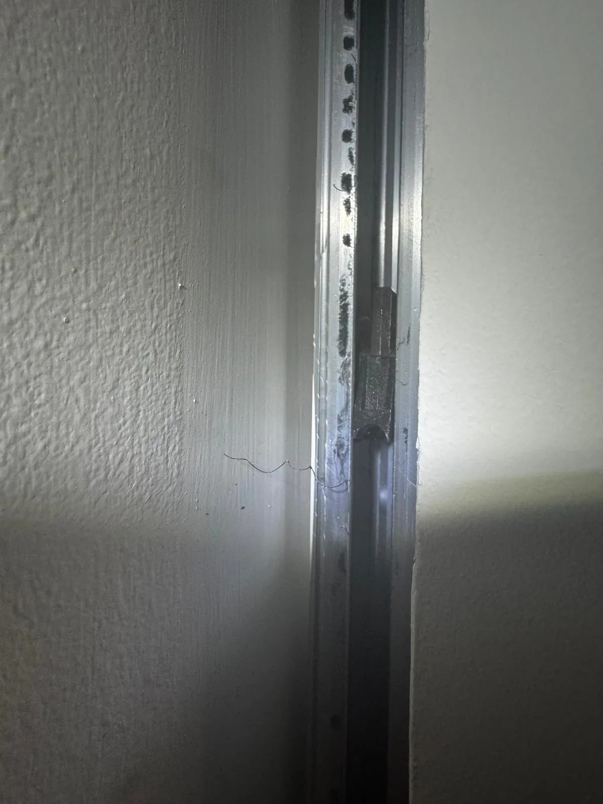 Sliding door track edge closeup