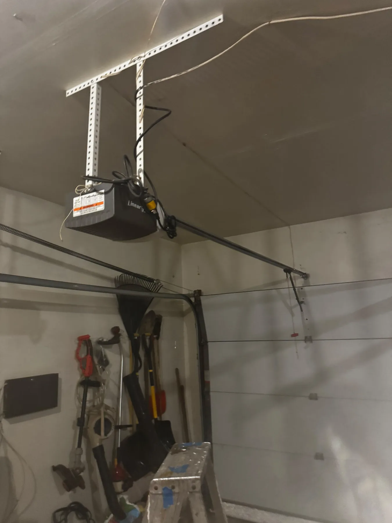 Garage opener motor mounted above door
