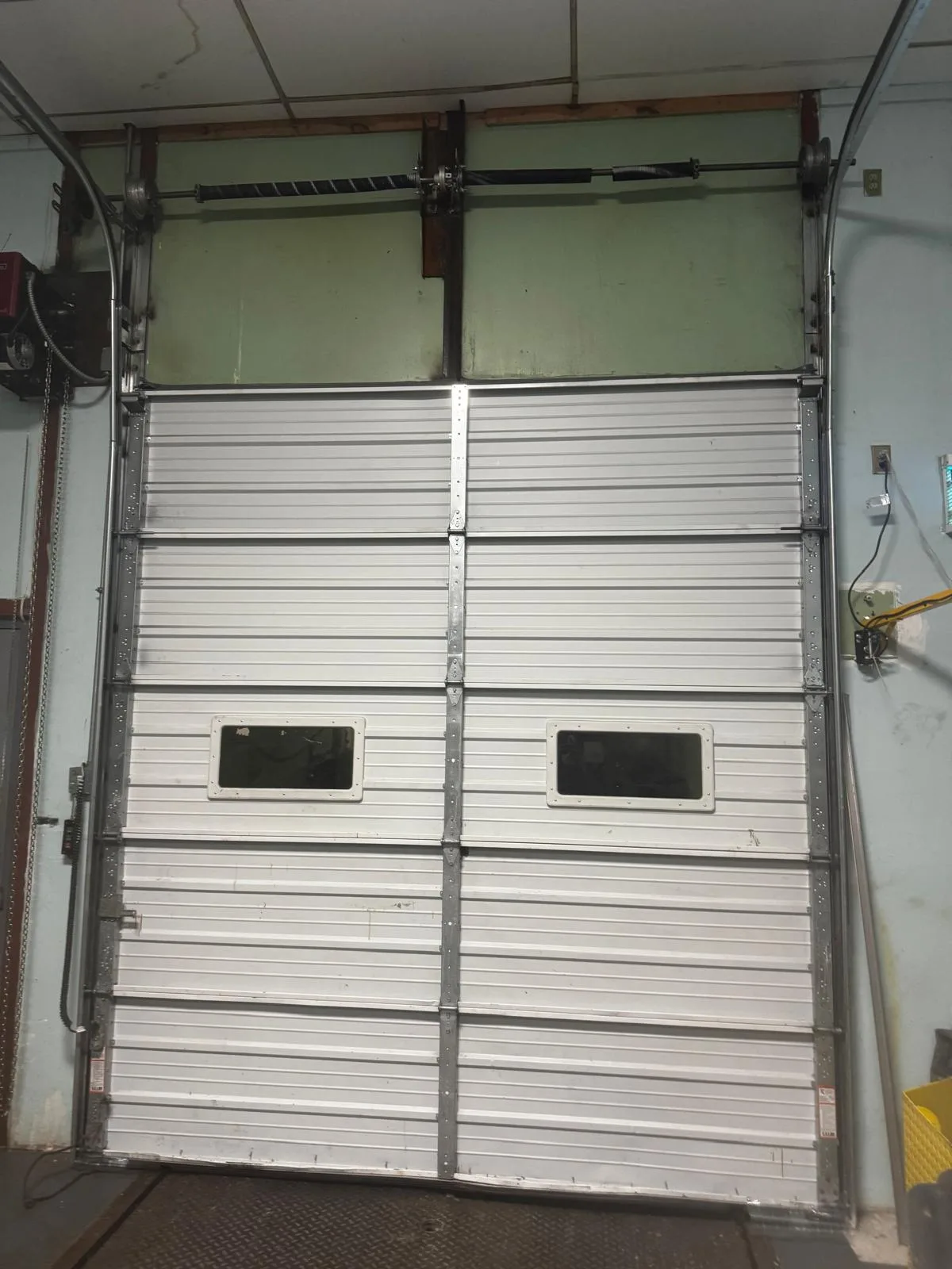 White commercial garage door before repair